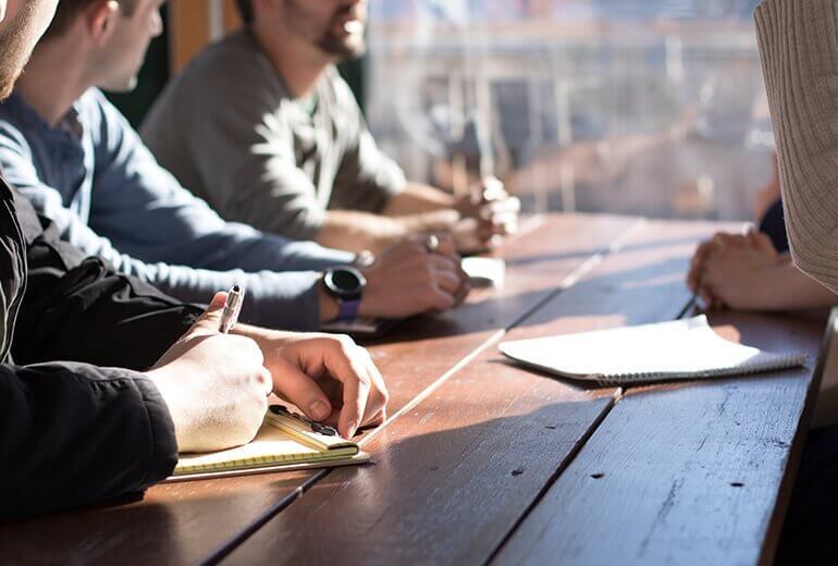 Men around table at soberliving facility