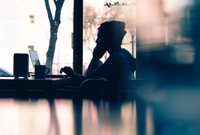 Man in coffee shop calling drug rehabs