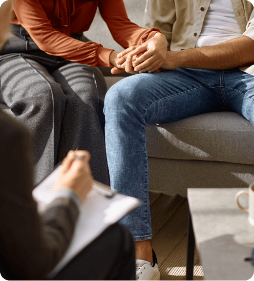 husband and wife holding hand during therapy