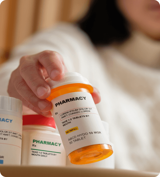 Woman showing prescription drug bottle