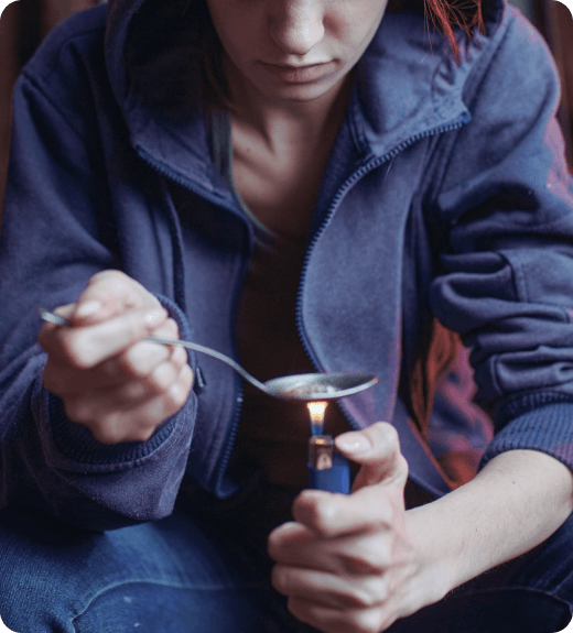 woman burning heroin with a spoon