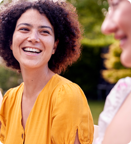 woman wear yellow shirt talking and laughing