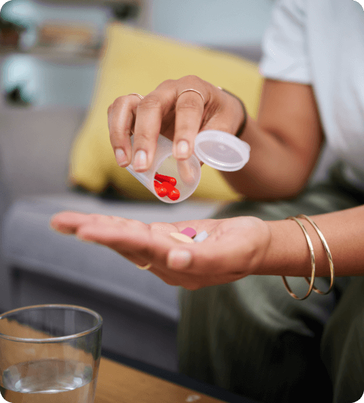 woman pouring pills into her hand