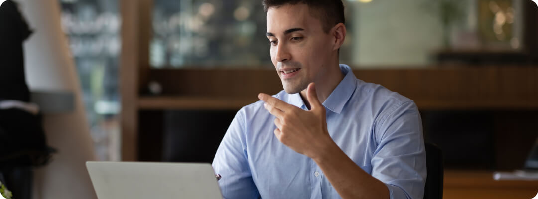 man talking looking at his laptop